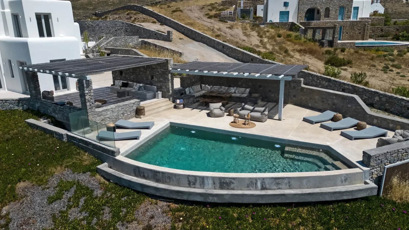 Aerial view of a villa terrace and curved swimming pool
