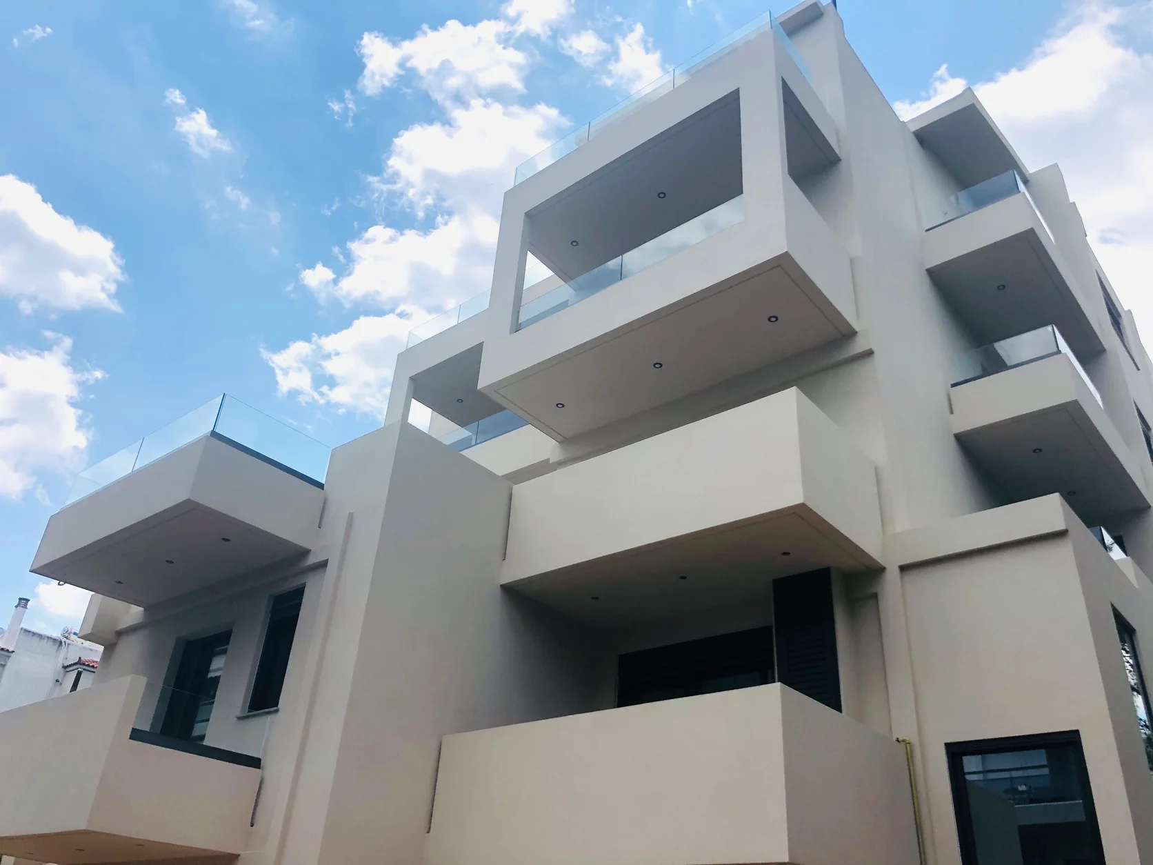 White residential facade viewed from the pavement