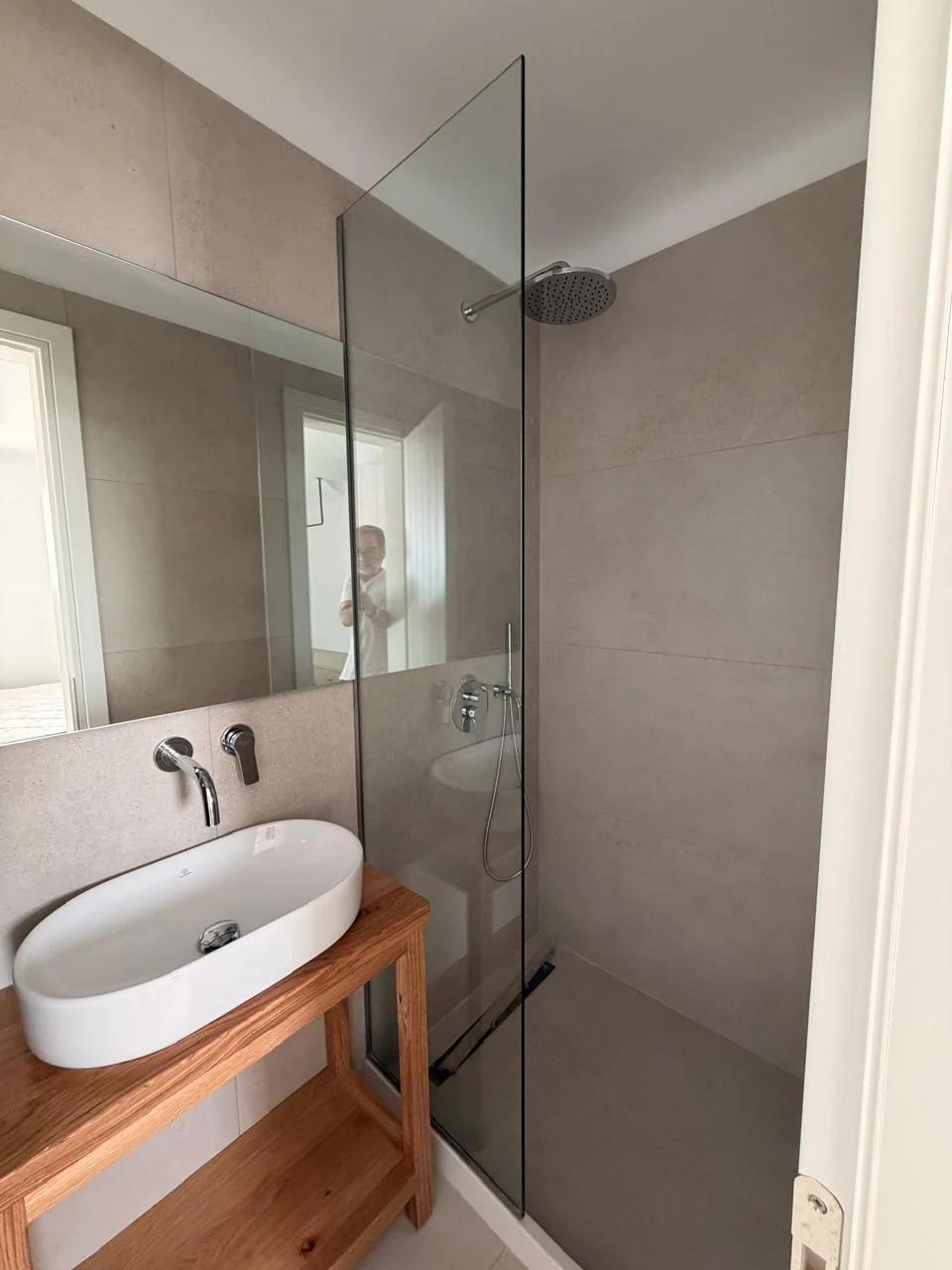 Paragka, Mykonos · Bathroom with glass shower enclosure and timber vanity.