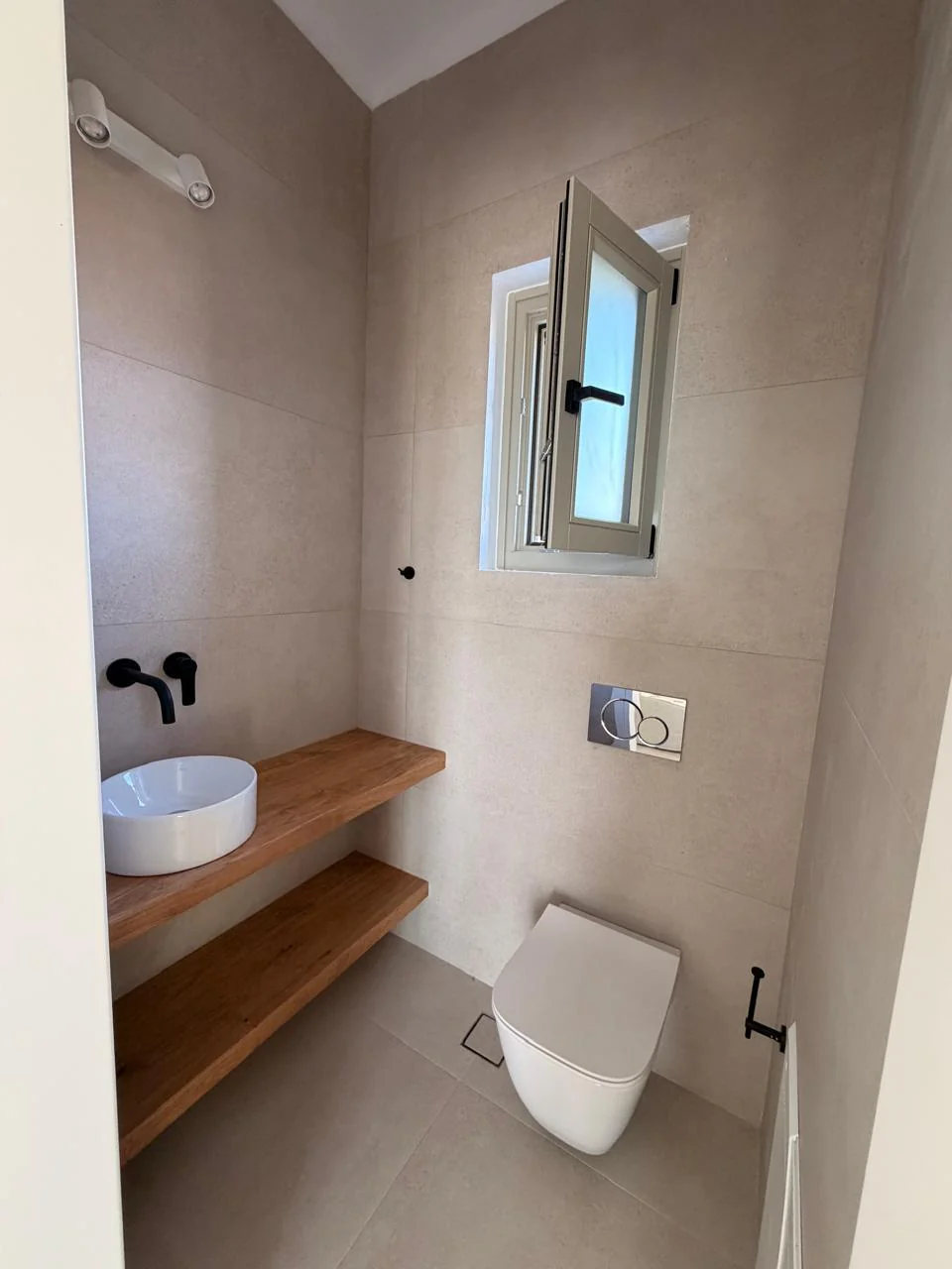 Paragka, Mykonos · Bathroom with timber vanity and natural daylight.